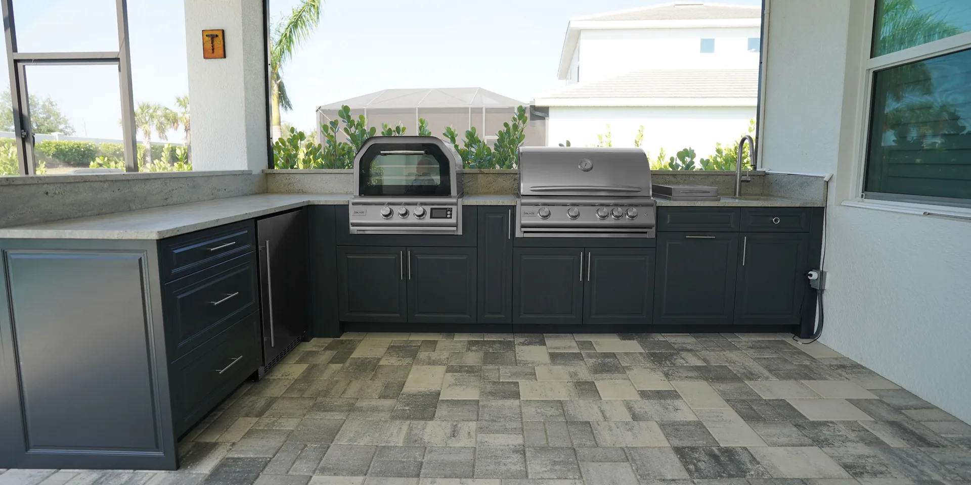 Covered outdoor kitchen with built-in grill and stone counters, illustrating a cooler backyard gathering space